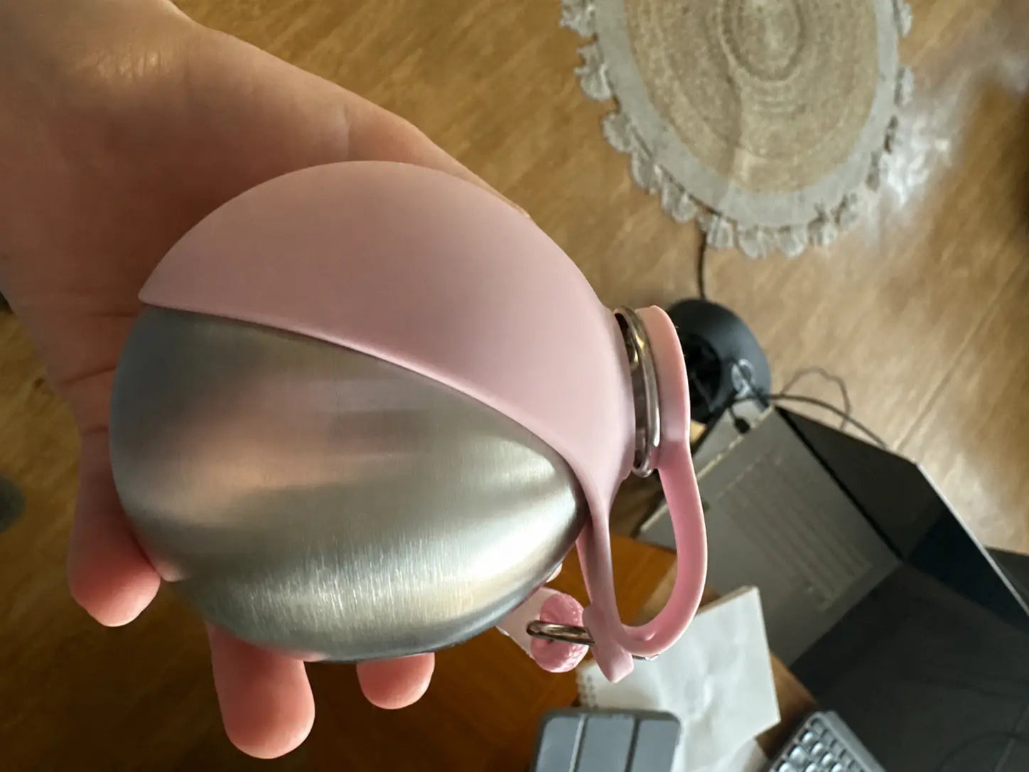 Pink PawCoop dog water bottle held in hand