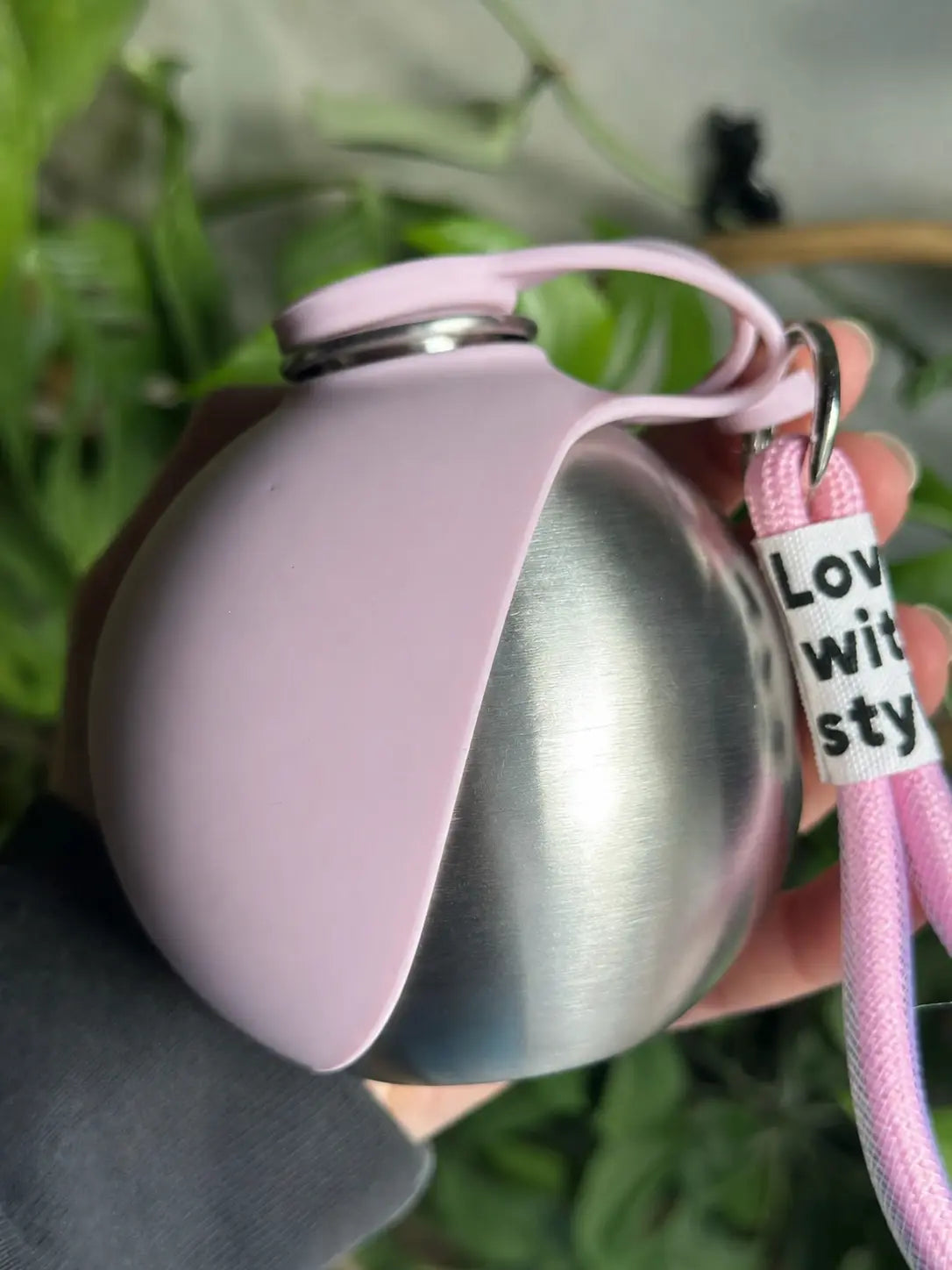 Pink PawCoop dog water bottle with a matching leash