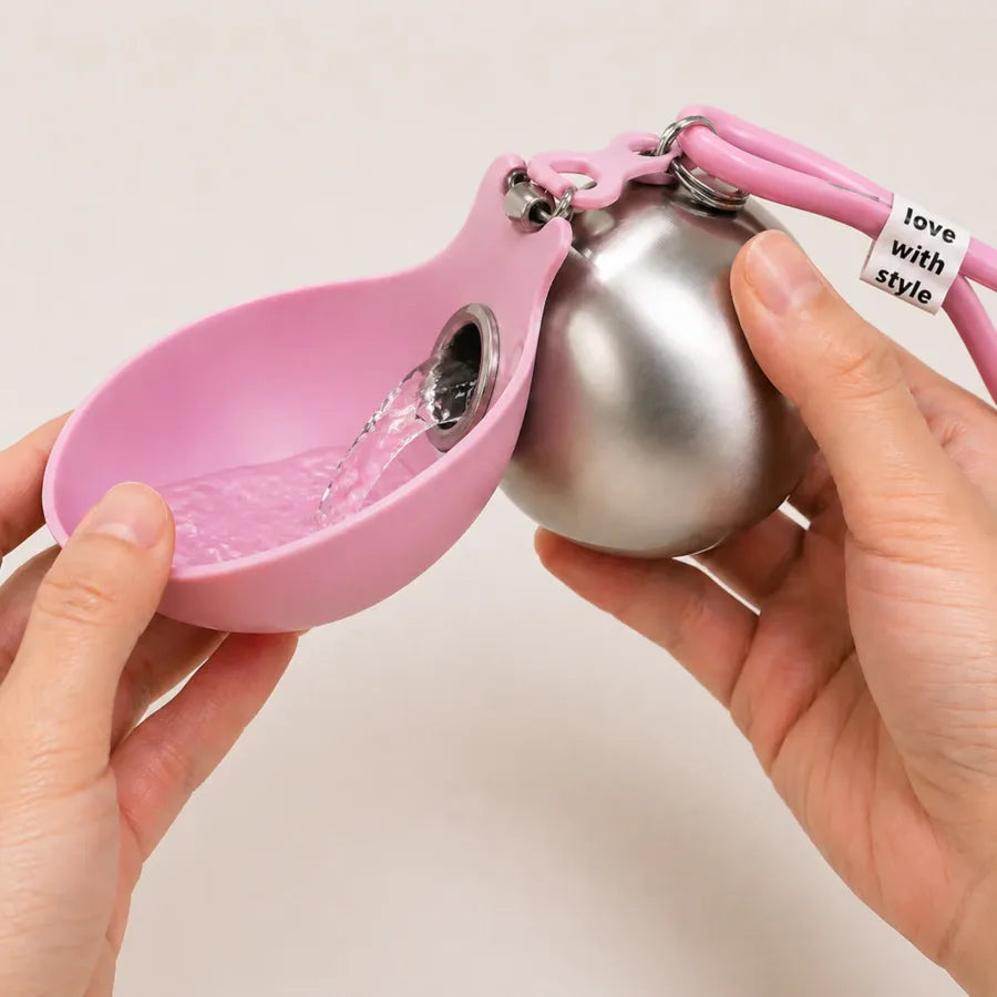 Water pouring from the bottle into the pink folded-out bowl